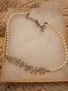 CHANEL-Inspired White Pearl Necklace with Gold Crystal Logo